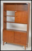A retro 20th Century teak wood Danish inspired room divider bookcase having an arrangement of