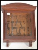 A late 19th/ early 20th Century oak wall hanging display cabinet, having single glazed door and