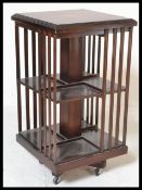 An Edwardian style mahogany inlaid  mahogany inlaid revolving bookcase raised on splayed legs with