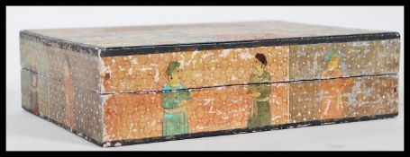 An early 20th Century lacquered Indian wooden box having hand painted decoration depicting a