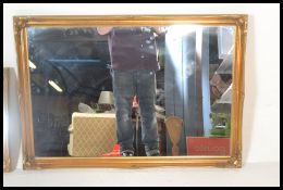 A pair  of contemporary 20th century wall mirrors having decorative gilt gesso style wall mirrors.