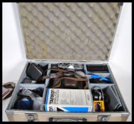 A Kweb Kiev 4A chrome USSR 20th Century camera, having its original leather case and having lens,