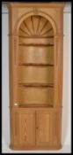 A Georgian revival 20th century pine open topped standing corner cupboard having adjustable