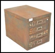 A vintage early 20th Century Industrial four drawer desk top filing cabinet, each drawer fitted with