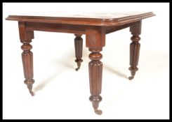 A 19th century Victorian mahogany extendable dining table, raised on fluted baluster legs