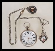 A silver hallmarked Kendal & Dent open face pocket watch having a white face with Arabic numerals to