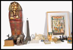A collection of Egyptian decorative items to include floor standing mummy sarcophagus, sphinx cat