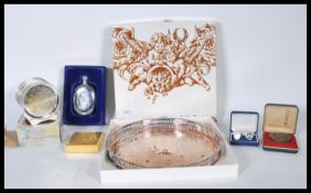 A collection of silver plated items to include a Viners fret pierced gallery tray, coasters, hip