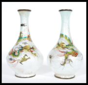 A pair of early 20th Century Chinese cloisonne vases having enamelled decoration of Chinese