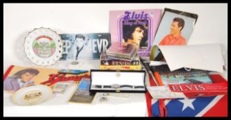 A collection of Elvis Presley music memorabilia to include pendants, fridge magnets, plates, key
