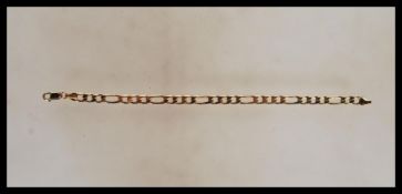 A 9ct gold triple link bracelet chain set with lobster clasp being stamped 375. Length 7