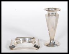 A silver hallmarked spill vase having a tapering faceted stem raised on a round base with a flared