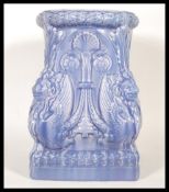 A 20th Century Art Nouveau ceramic Majolica plant stand finished in blue, having lions/ griffins