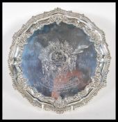 A 19th Century Victorian silver hallmarked tray of round form having having gadrooned and scrolled