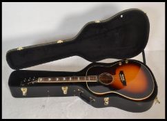 A six string electric acoustic replica guitar, sunburst body with applied paper label to the inside,