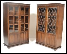 A pair of 20th century Priory oak cabinet. Each with chamfered edge tops over cabinets beneath