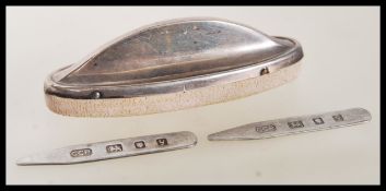 A pair of silver hallmarked collar stiffeners together with a silver hallmarked nail buffer.