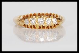 A hallmarked 18ct gold ladies ring set with five brilliant cut diamonds. Estimated diamond total