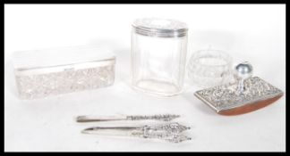 A selection of silver hallmarked dressing table items to include a Walker & Hall cut glass