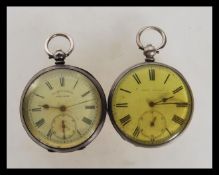 Two silver open face pocket watches, both having white enamelled dials with roman numerals to the