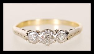 An early 20th Century stamped 18ct gold ring having three illusion set diamonds to the head.