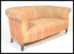 A late 19th / early 20th Century Chesterfield two seat sofa settee being upholstered in a period
