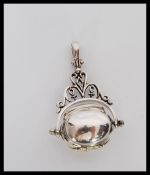 A silver ladies revolving 3 section locket pendant. Stamped 925. Weighs 11.2g.
