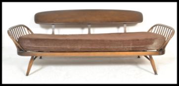 An 20th Century original Ercol 1970's day bed sofa settee with brown cushion in good order. Mid dark