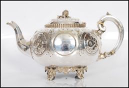 A 19th Century Victorian silver plate teapot having repousse and engraved floral decoration raised
