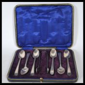 A 20th Century James Deakin & Sons cased set of six tea spoons along with a pair of sugar tongs.