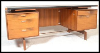 A large mid century / 1970's Danish influence teak wood twin pedestal desk. Raised on legs with