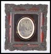 A 19th Century Victorian wet plate photograph of a Victorian couple having applied pink hues to