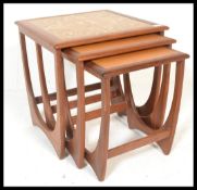 A set of three 20th Century graduating teak G Plan 1970's occasional / nest of tables, the largest