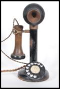 A vintage early 20th Century stick telephone of brass construction having bakelite mouth and