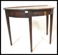 A 19th century George III mahogany demi lune hall table being raised on squared legs with half