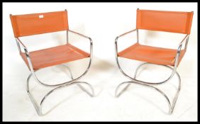 A pair or retro 20th Century chrome framed cantilever armchairs in the manner of Mart Stam, the seat
