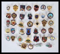 A collection of vintage miscellaneous enamelled lapel badges to include a selection of Welsh