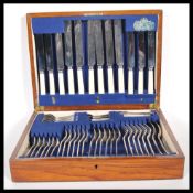 An Elkington canteen of cutlery for six including bone handled knives set within an oak case with