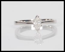 A hallmarked 9ct white gold ring having marquise cut prong set single stone diamond. Weighs 2.8g.