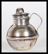 A silver hallmarked scent bottle having a bulbous form body with lid to the top, inscribed to the