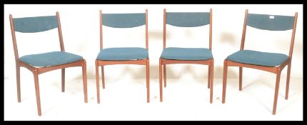 A set of four vintage mid 20th century teak wood dining chairs, upholstered drop in seat pads and