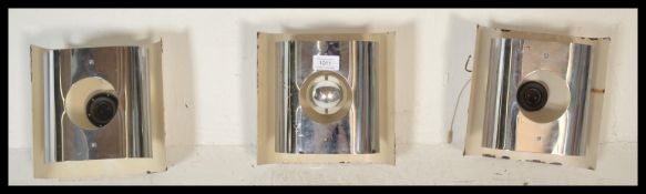 A set of 3 retro 20th Century circa 1970's chrome wall lights having pull cords to each, chrome