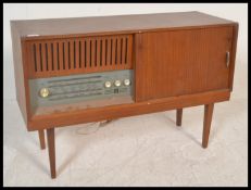 A vintage retro 20th Century teak wood cased radiogram containing a four speed BSR record deck