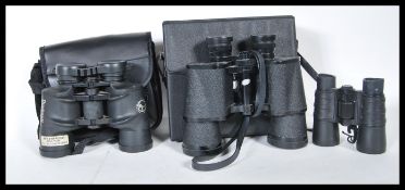 A group of three binoculars to include, a pair of Tasco fully coated lightweight binoculars in