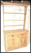 A Victorian 19th century pine country Welsh Dresser. The base with short drawers over double door