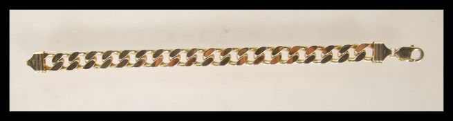 A stamped 925 silver gold plated flat link bracelet having a lobster clasp. Weight 64.1g. Measures 9