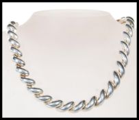 A stamped 925 silver necklace chain having a large twisted link design and a tongue in groove clasp.