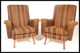 A pair of 20th Century vintage / retro fireside easy lounger armchairs being upholstered in wool