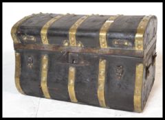 An 18th century black leather and brass bound dome top travelling trunk, leather handles to sides