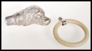 A early 20th Century child's teething ring, with a filled silver hallmarked figure in the form of
